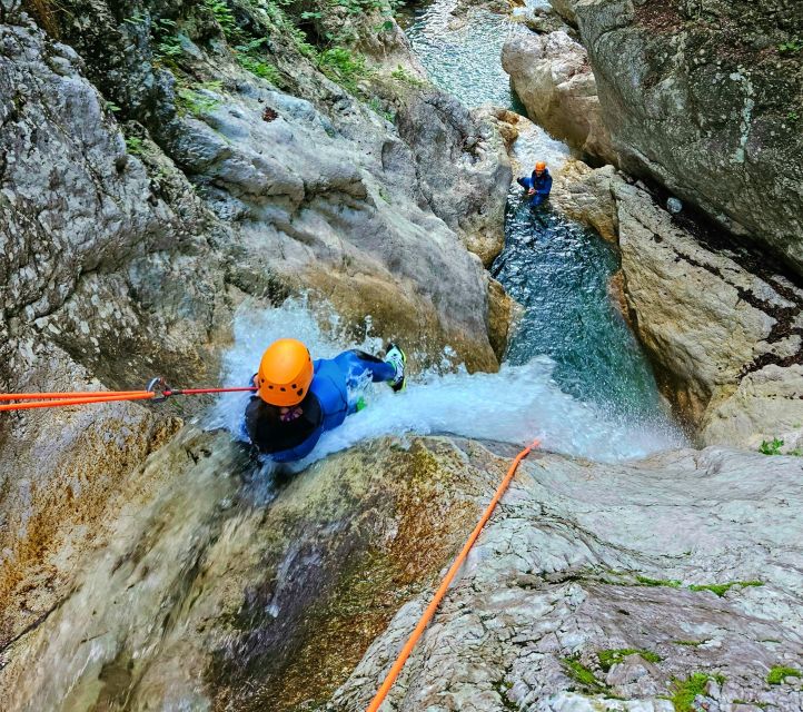 Bovec: Canyoning for Beginners Experience - Slipping into the water at Sušec